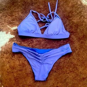 Rip Curl blue surf bikini; cross back, cheeky bottoms w scrunch. Size XS.